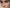 Extreme close-up of a woman's face showing detailed skin texture, natural skin tone, and green eyes.